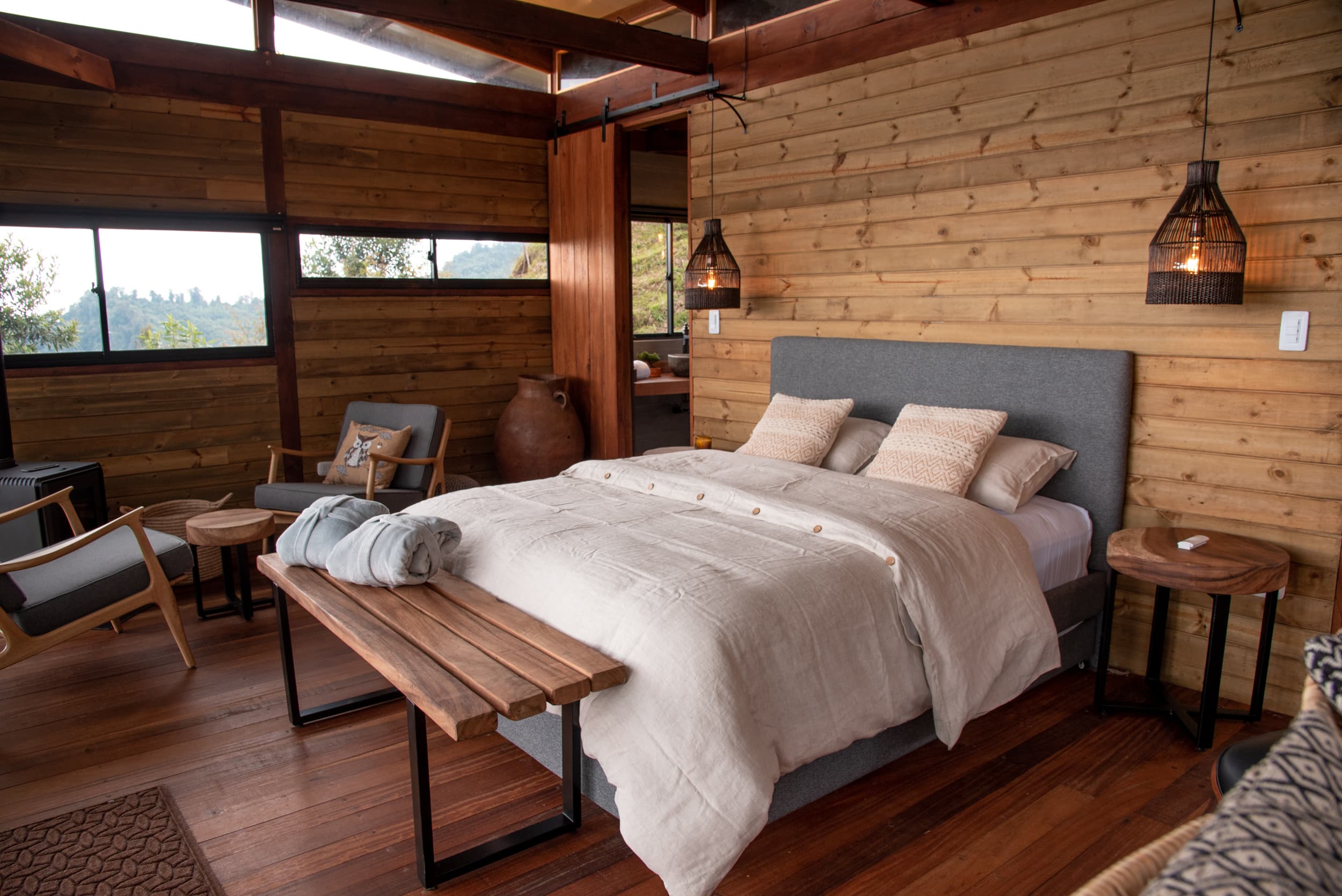 Cabin bedroom with queen bed and wood walls